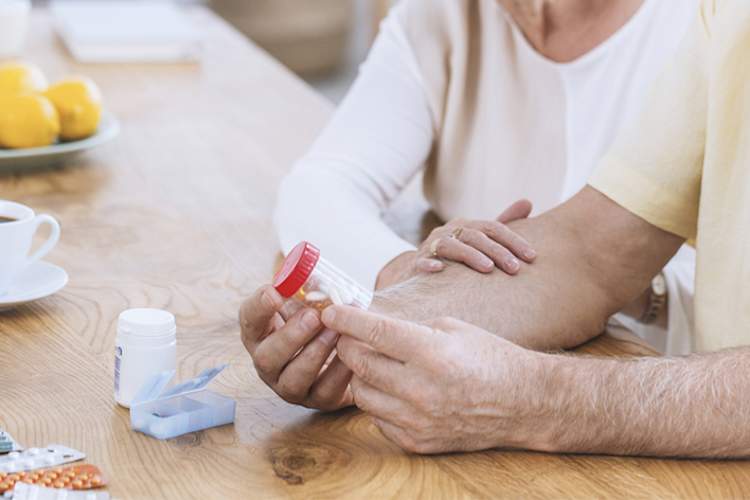 Woman supporting senior man with diabetes.