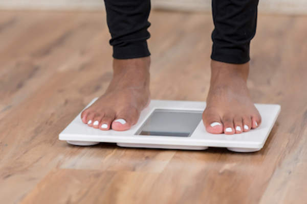 Checking weight on bathroom scale.