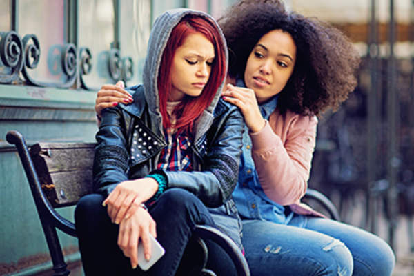 Woman consoling a friend.