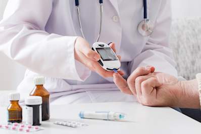 Doctor testing blood sugar with diabetes medications.