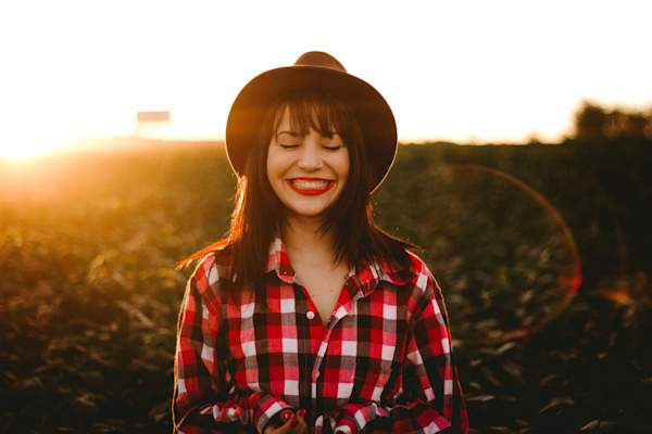 woman with eyes closed smiling in sunlight