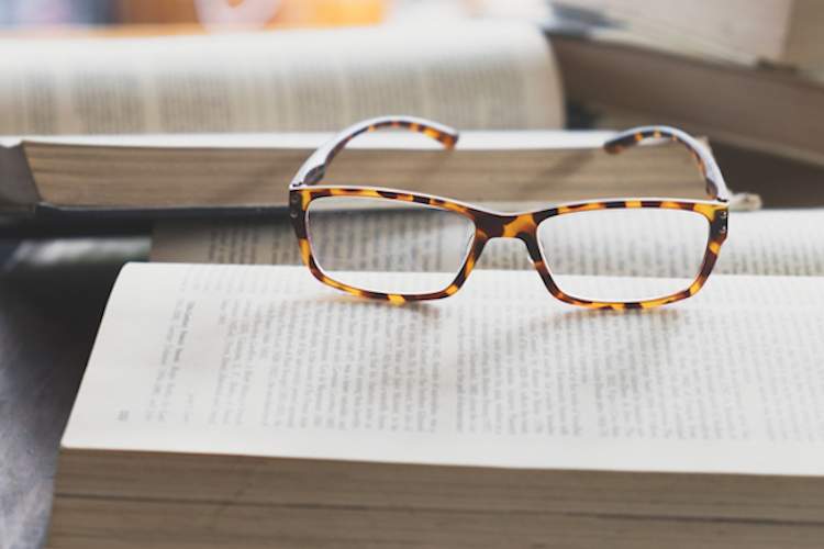 Eyeglasses on open book.