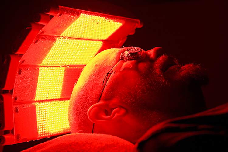 Man undergoing phototherapy treatment for psoriasis.