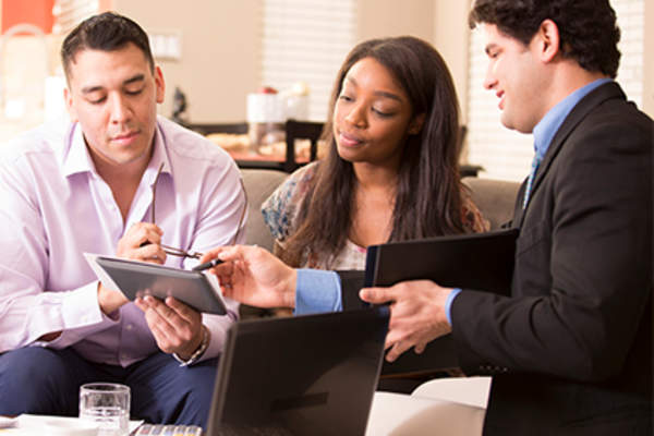 Young married couple meeting with financial planner.