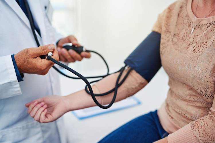 Cropped shot of a male doctor checking his patient's blood pressure