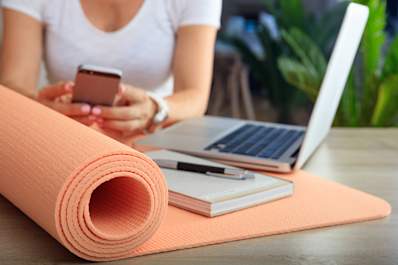 Close up of young woman looking up exercise information online.