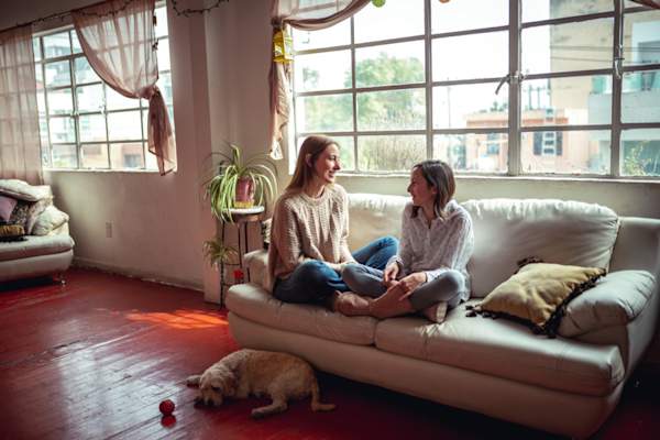 mother and daughter talking on couch