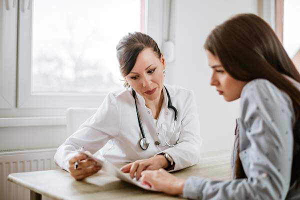 Doctor walking patient through information.