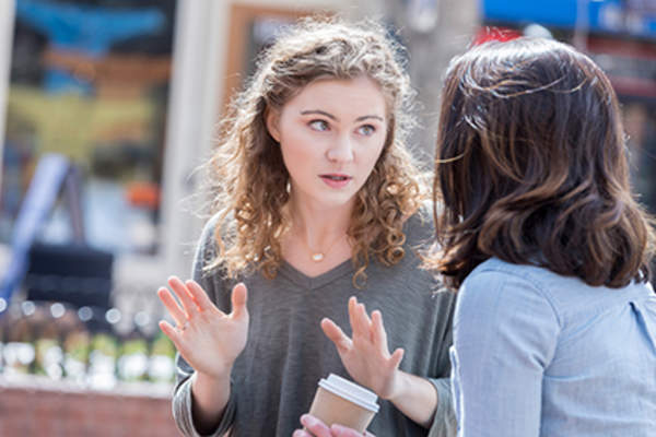 Woman explaining something to her sister.