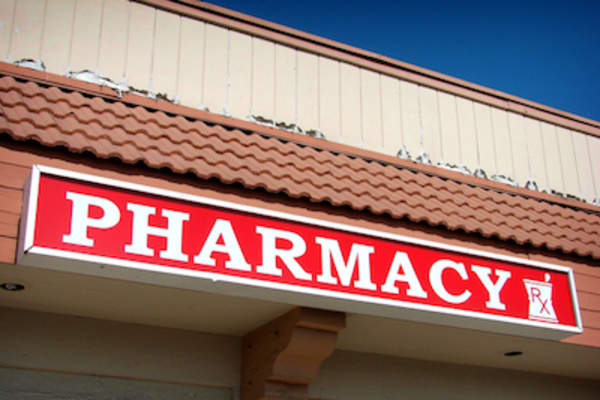 Pharmacy sign on building.