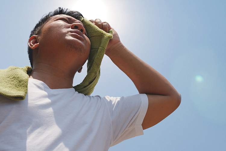 Man sweating outside in the sun.