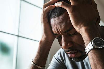 Distressed man struggling with chronic hives.