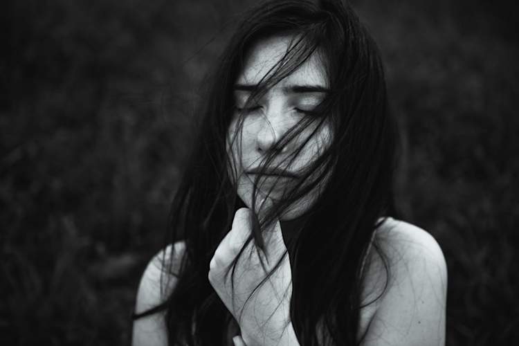 black and white portrait of woman with her eyes closed