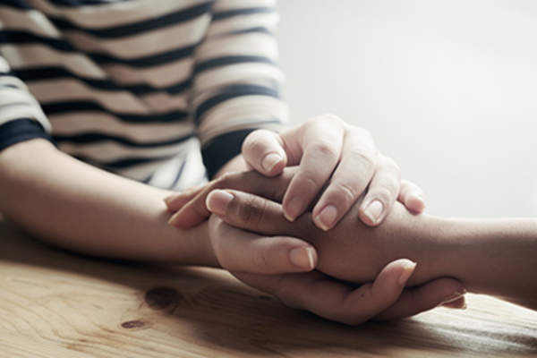 Holding hands and providing support and forgiveness.