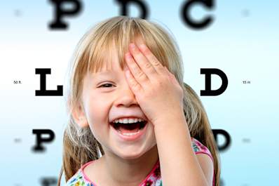 Happy young girl at eye exam.