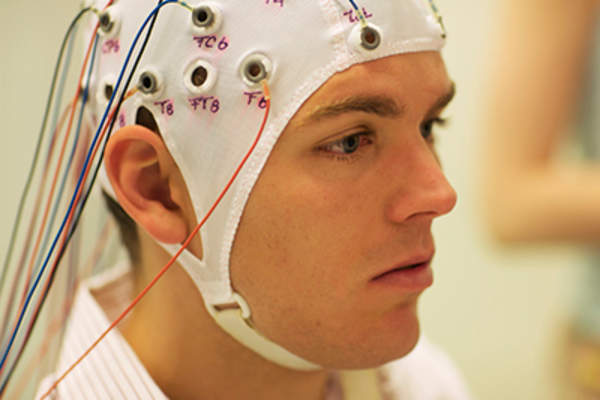 Man connected with cables for an EEG.