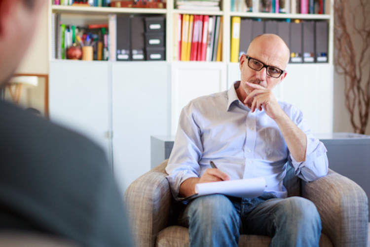 Patient talks while phycotherapist takes notes