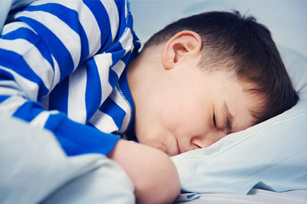 Boy having a nightmare in bed.