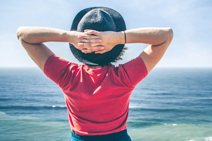 woman at beach looking at ocean image