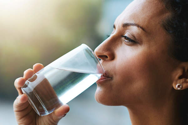 Woman drinking glass of water.