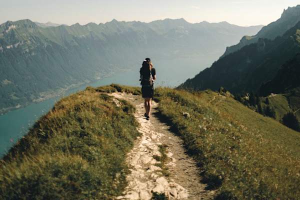 man hiking on beaten path