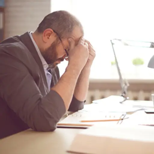 Man stressed while working in an office