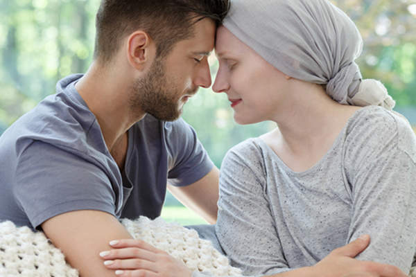 Husband supporting wife with cancer image.