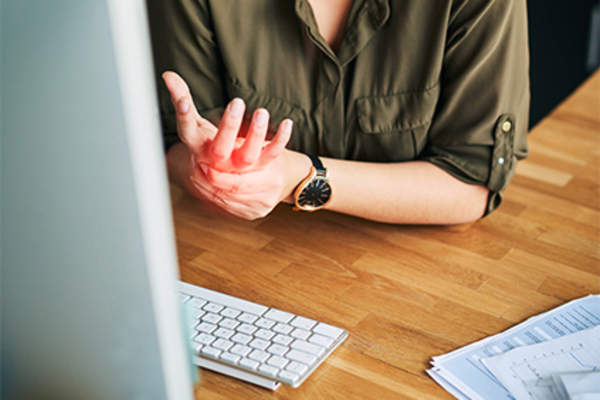 Woman with wrist pain at work.