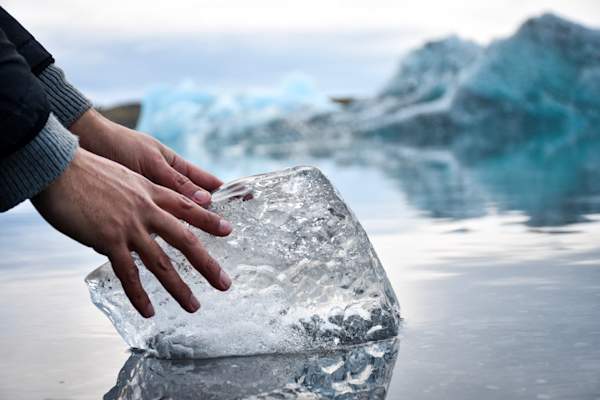 Hands touching ice block