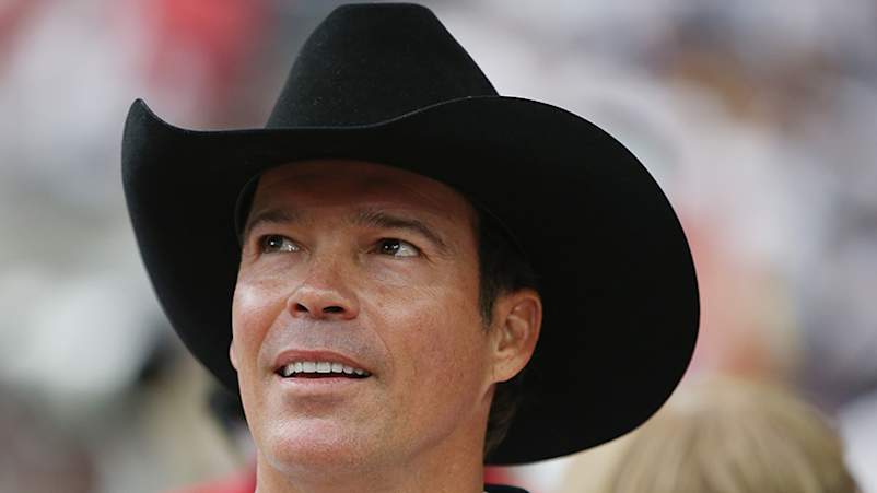Country music singer Clay Walker waits on the field with his son Cal before their game against the Kansas City Chiefs