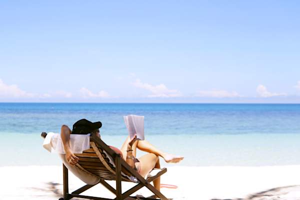 woman reading on the beach