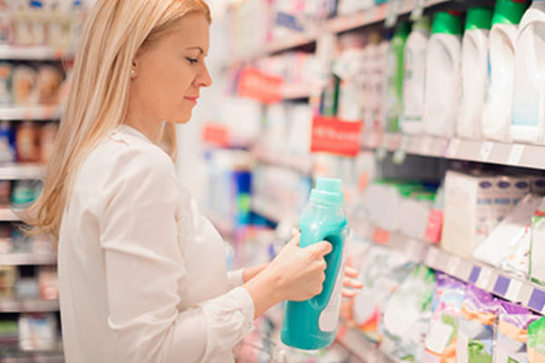Woman picking out a laundry detergent.