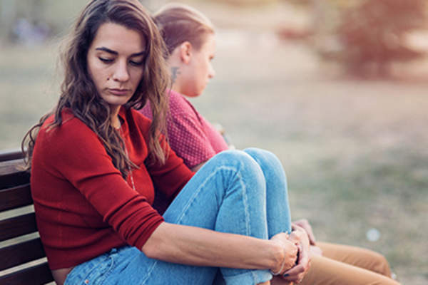 Sad woman on a bench.