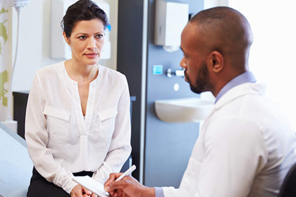 doctor talking to woman about medical tests image
