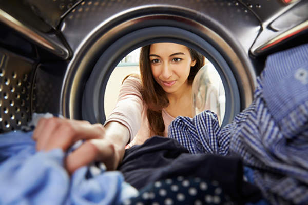 woman getting clothes out of dryer image