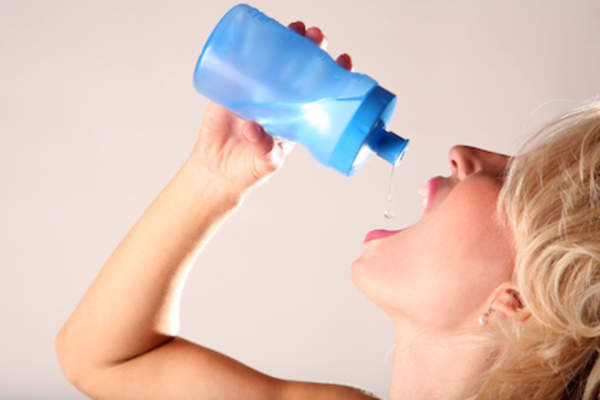 Woman drinking water to quench dry mouth