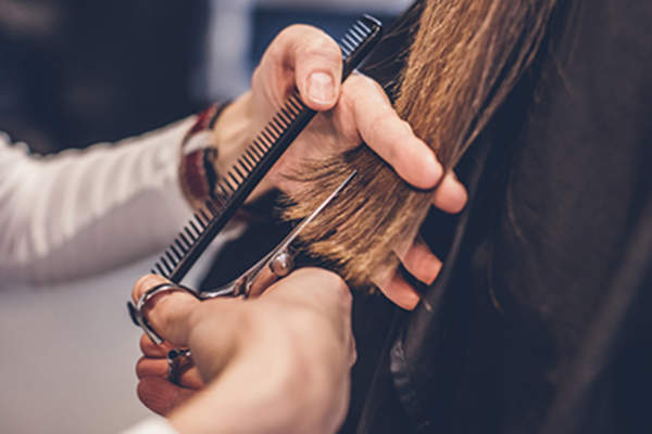 Hairdresser cutting hair.