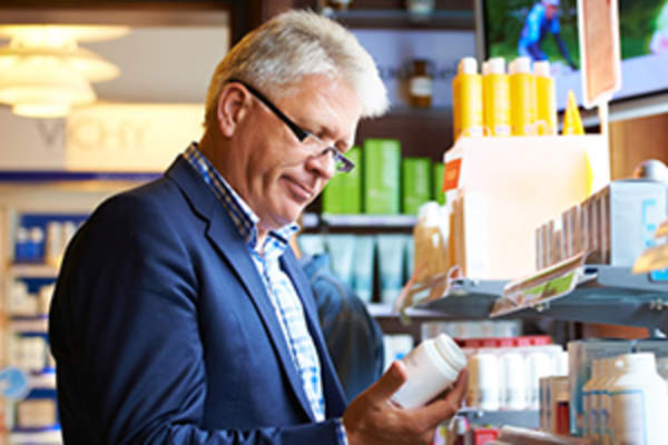 man looking at multivitamins image