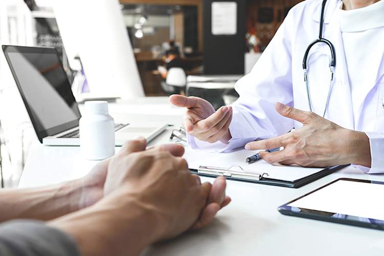 Doctor explaining diagnosis to a patient.