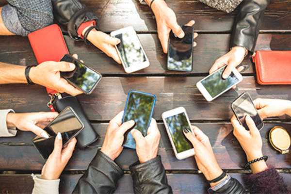 Group of people with cell phones.