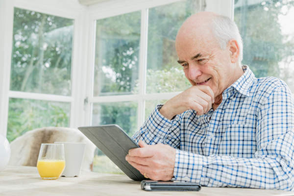 man reading a tablet in a room with natural light image