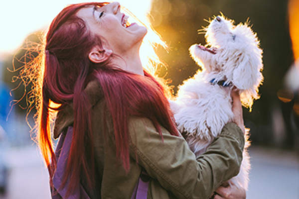 Happy woman smiling with her dog.
