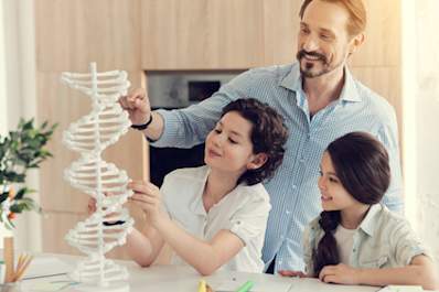 Father building double helix model with daughters.