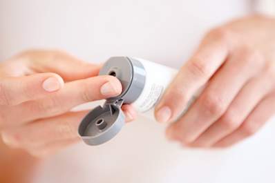 Woman squeezing lotion tube