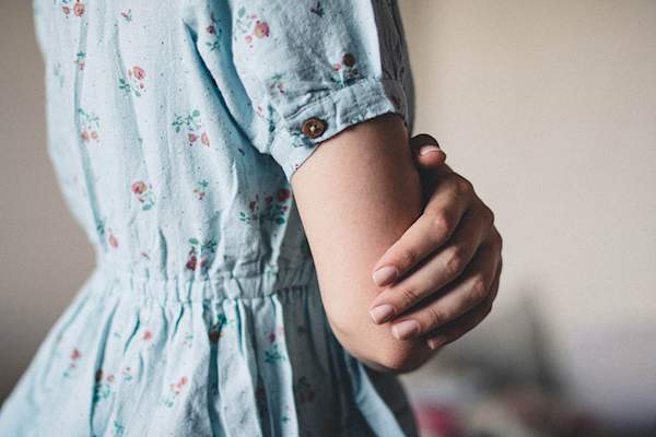 Woman touching her arm