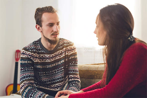 Young couple talking at home.