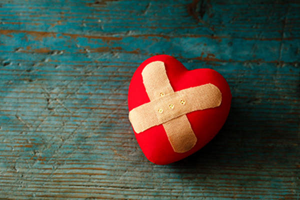 Damaged heart with a bandage.