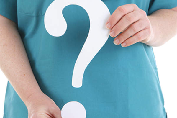 Medical question concept, doctor holding question mark.