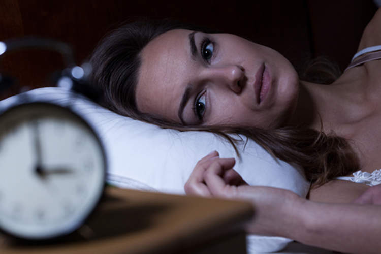Woman with insomnia in the middle of the night image.