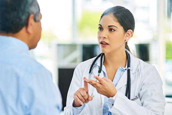 Doctor discussing care plan and long-term treatment with male patient.